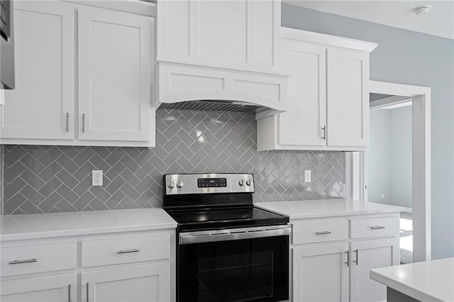 19499 W 114th Ter, Olathe, KS 66061 - kitchen with stainless steel range with electric stovetop, premium range hood, light countertops, and tasteful backsplash
