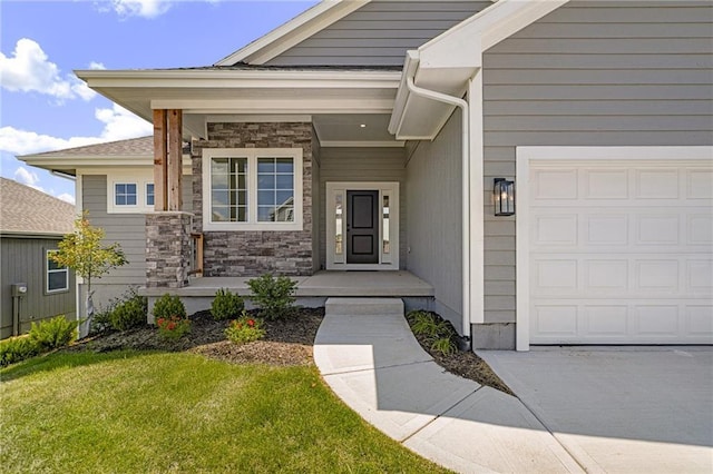19499 W 114th Ter, Olathe, KS 66061 - property entrance with an attached garage, a yard, stone siding, and a porch