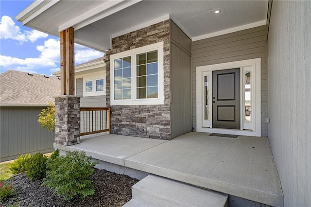 19499 W 114th Ter, Olathe, KS 66061 - view of exterior entry featuring stone siding and a porch