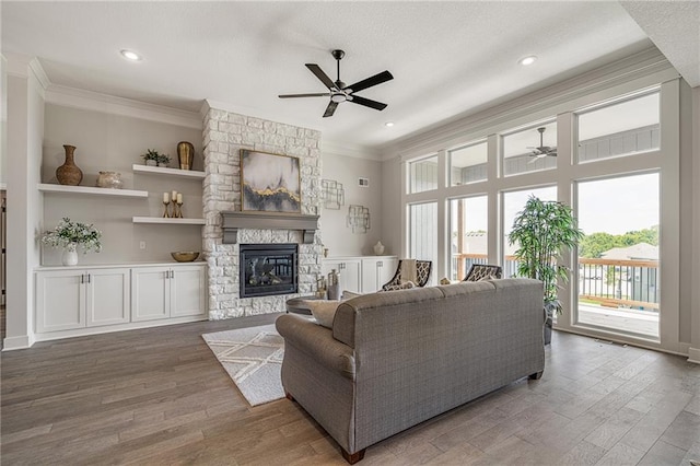 19499 W 114th Ter, Olathe, KS 66061 - living area with ceiling fan, ornamental molding, wood finished floors, a fireplace, and recessed lighting