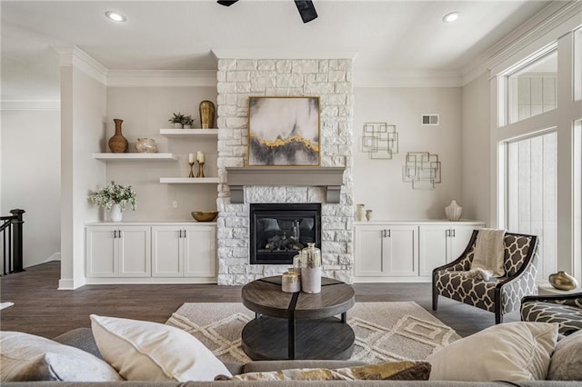 19499 W 114th Ter, Olathe, KS 66061 - living room featuring crown molding, dark wood-style flooring, a fireplace, and recessed lighting