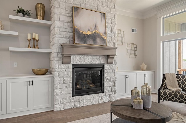 19499 W 114th Ter, Olathe, KS 66061 - living area featuring wood finished floors, a fireplace, and ornamental molding