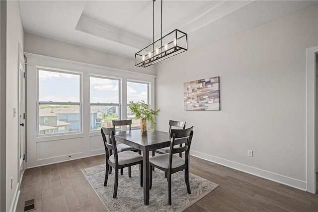 19499 W 114th Ter, Olathe, KS 66061 - dining room featuring dark wood-style floors, a chandelier, and a tray ceiling