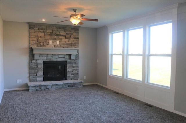 19444 W 114th Ter, Olathe, KS 66061 - unfurnished living room with a ceiling fan, carpet flooring, and a stone fireplace