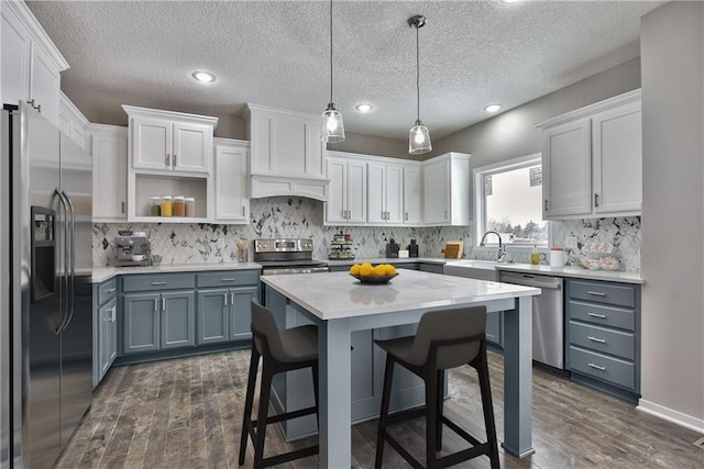 19444 W 114th Ter, Olathe, KS 66061 - kitchen featuring stainless steel appliances, dark wood finished floors, light countertops, white cabinets, and recessed lighting