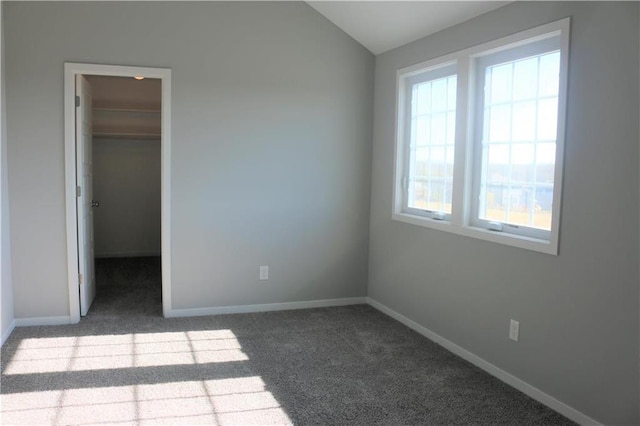 19444 W 114th Ter, Olathe, KS 66061 - unfurnished bedroom featuring carpet flooring, a walk in closet, vaulted ceiling, and a closet