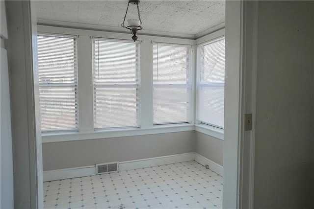 1101 S Broadway St, Leavenworth, KS 66048 - unfurnished sunroom featuring baseboards and tile patterned floors
