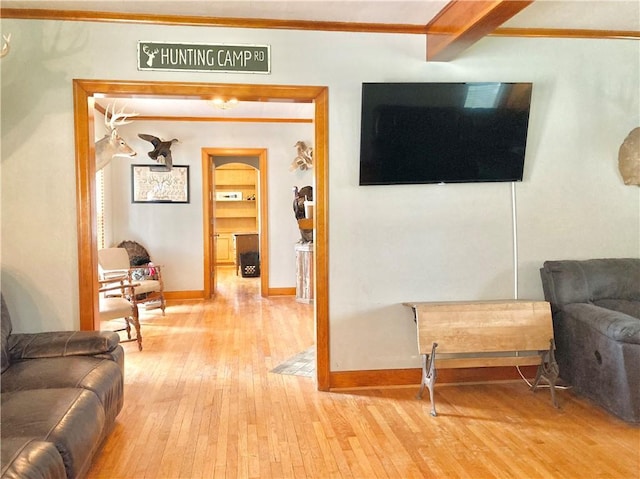 406 S 6th St, Burlington, KS 66839 - living room featuring light wood-style floors, crown molding, and arched walkways