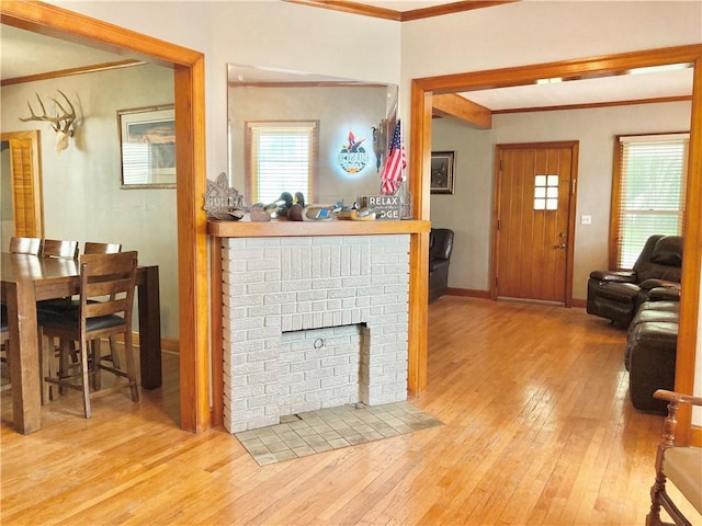 406 S 6th St, Burlington, KS 66839 - living area with ornamental molding, wood-type flooring, and a fireplace