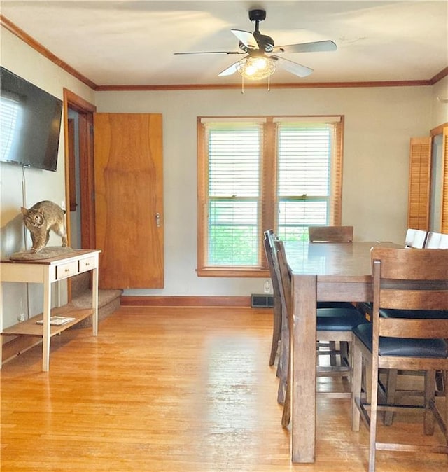 406 S 6th St, Burlington, KS 66839 - dining area featuring light wood finished floors, crown molding, and a ceiling fan