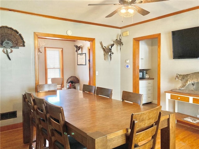 406 S 6th St, Burlington, KS 66839 - dining room with wood finished floors, ceiling fan, and ornamental molding