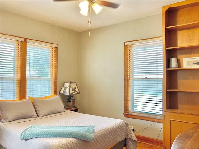 406 S 6th St, Burlington, KS 66839 - bedroom with multiple windows, wood finished floors, and a ceiling fan