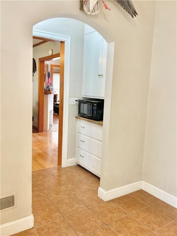 406 S 6th St, Burlington, KS 66839 - hall with light tile patterned floors and arched walkways