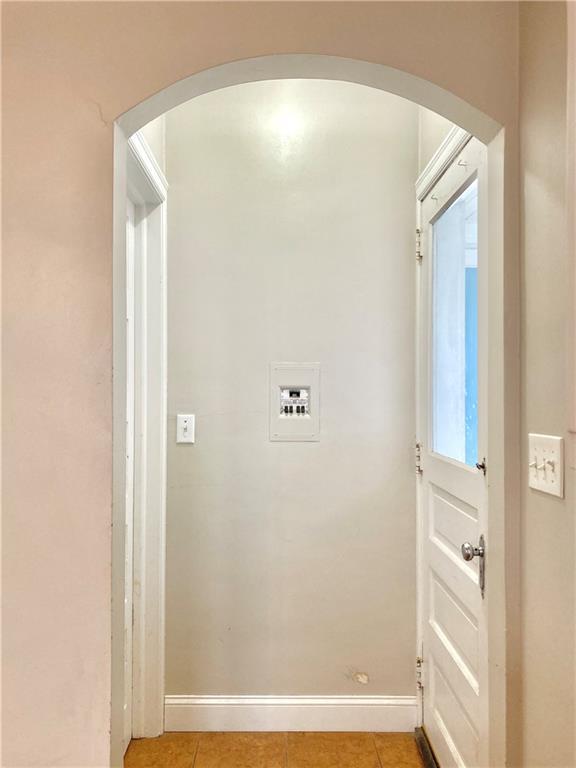 406 S 6th St, Burlington, KS 66839 - laundry room featuring arched walkways and light tile patterned floors