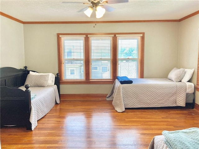 406 S 6th St, Burlington, KS 66839 - bedroom featuring ornamental molding, light wood-type flooring, and a ceiling fan