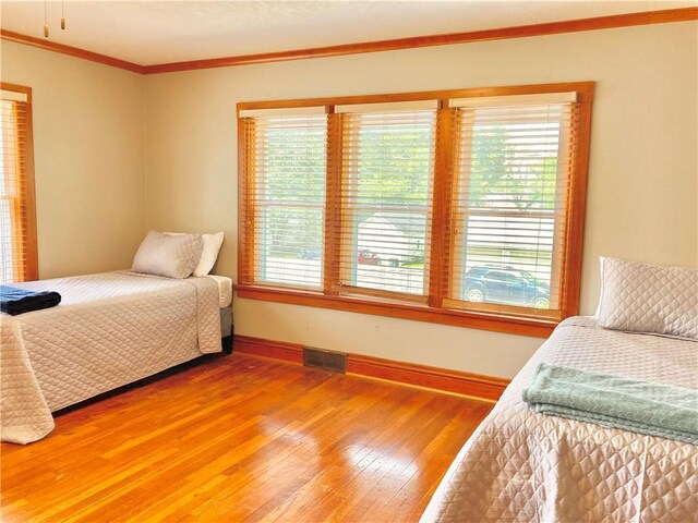 406 S 6th St, Burlington, KS 66839 - bedroom featuring multiple windows, ornamental molding, and light wood-type flooring