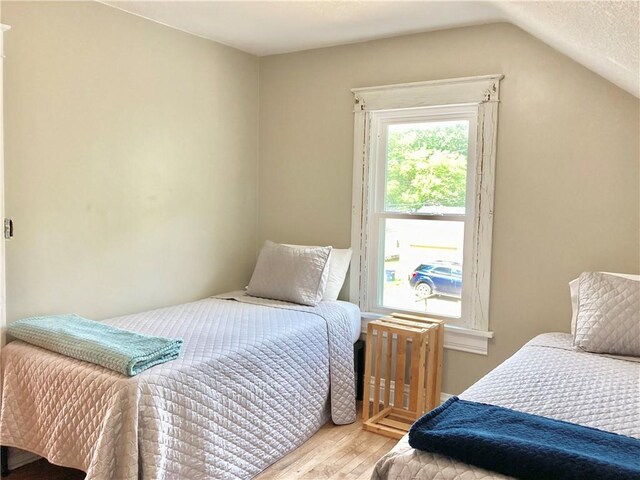 406 S 6th St, Burlington, KS 66839 - bedroom featuring wood finished floors, lofted ceiling, and radiator