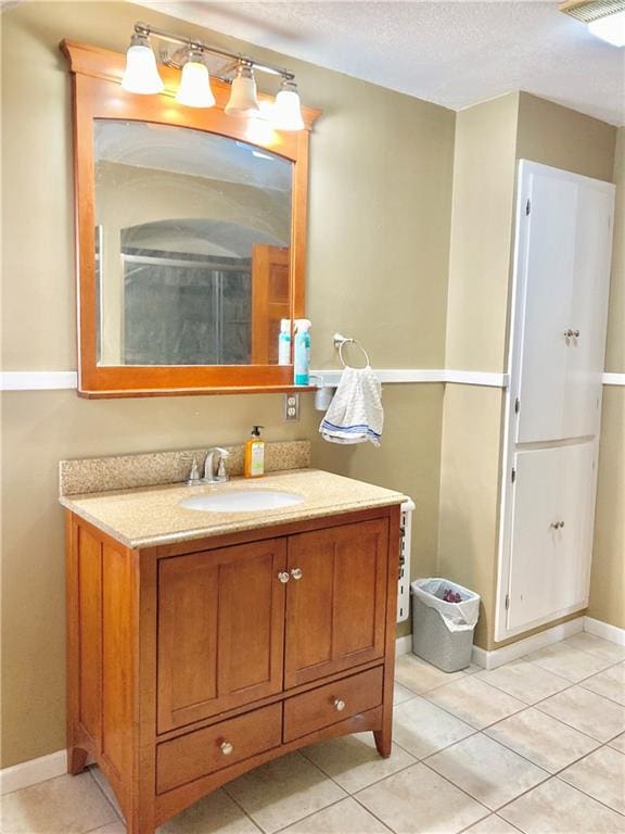 406 S 6th St, Burlington, KS 66839 - bathroom featuring vanity, tile patterned flooring, and a textured ceiling