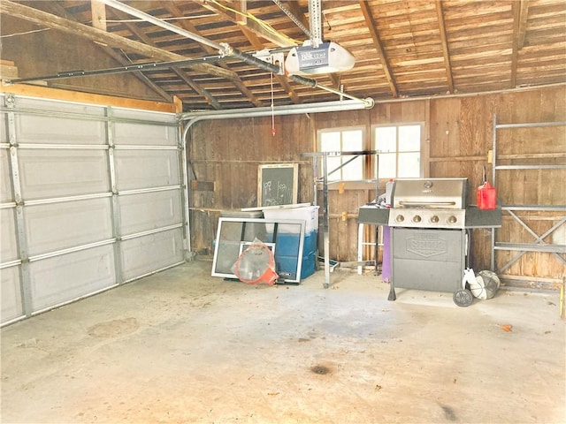 406 S 6th St, Burlington, KS 66839 - garage featuring a garage door opener and wood walls