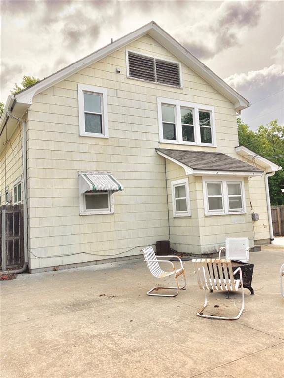 406 S 6th St, Burlington, KS 66839 - rear view of property featuring roof with shingles and a patio