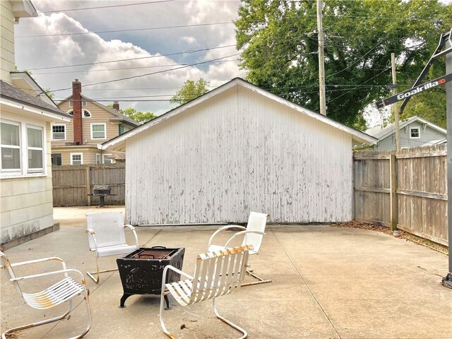406 S 6th St, Burlington, KS 66839 - fenced backyard featuring a fire pit, a patio, and a grill