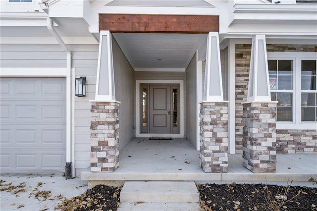 19455 W 114th Ter, Olathe, KS 66061 - view of exterior entry featuring stone siding and a garage
