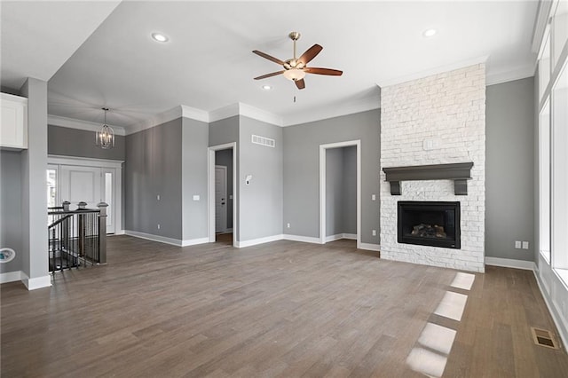 19455 W 114th Ter, Olathe, KS 66061 - unfurnished living room featuring ceiling fan, dark wood-type flooring, a fireplace, recessed lighting, and ornamental molding