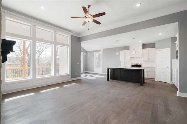 19455 W 114th Ter, Olathe, KS 66061 - kitchen featuring stainless steel range oven, light countertops, ceiling fan, white cabinets, and a center island with sink