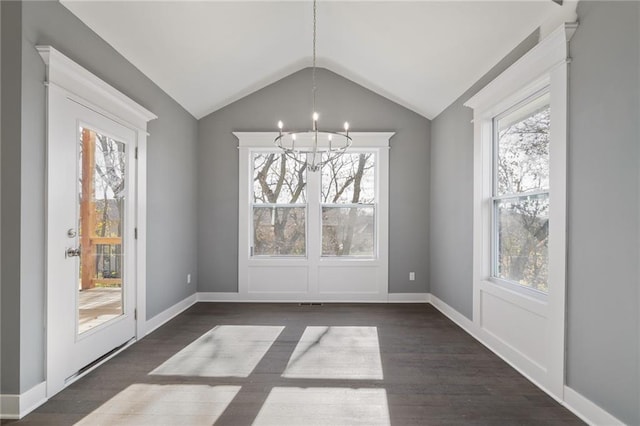 19455 W 114th Ter, Olathe, KS 66061 - unfurnished dining area with healthy amount of natural light, a chandelier, dark wood-style flooring, and vaulted ceiling