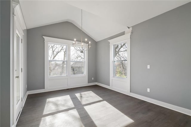 19455 W 114th Ter, Olathe, KS 66061 - unfurnished dining area featuring a chandelier, plenty of natural light, dark wood-type flooring, and lofted ceiling