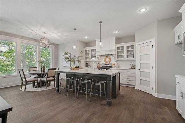 19345 W 114th Ter, Olathe, KS 66061 - kitchen featuring stainless steel range oven, light countertops, dark wood finished floors, a center island with sink, and recessed lighting