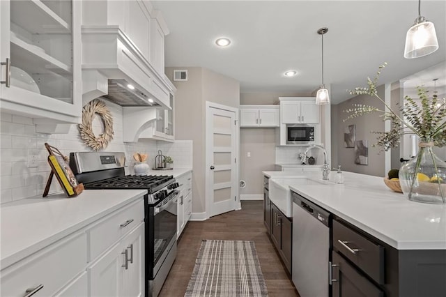 19345 W 114th Ter, Olathe, KS 66061 - kitchen featuring appliances with stainless steel finishes, white cabinets, glass insert cabinets, hanging light fixtures, and recessed lighting