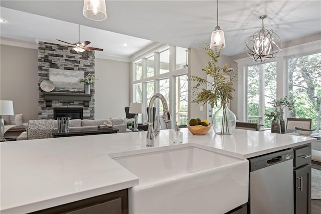 19345 W 114th Ter, Olathe, KS 66061 - kitchen with stainless steel dishwasher, crown molding, ceiling fan, open floor plan, and a stone fireplace