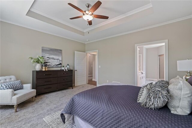 19345 W 114th Ter, Olathe, KS 66061 - carpeted bedroom featuring a tray ceiling, crown molding, connected bathroom, and a ceiling fan