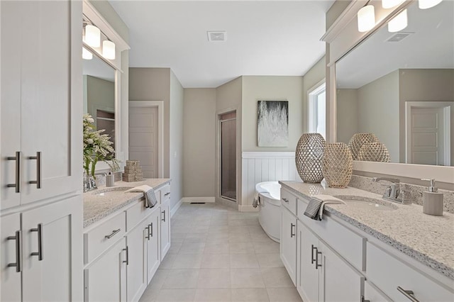 19345 W 114th Ter, Olathe, KS 66061 - bathroom featuring two vanities, a shower stall, a freestanding tub, and tile patterned flooring
