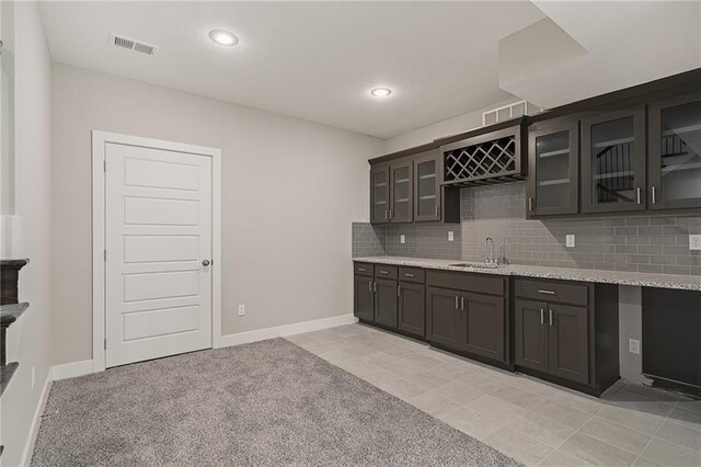 19345 W 114th Ter, Olathe, KS 66061 - kitchen with decorative backsplash, glass insert cabinets, light stone countertops, and recessed lighting