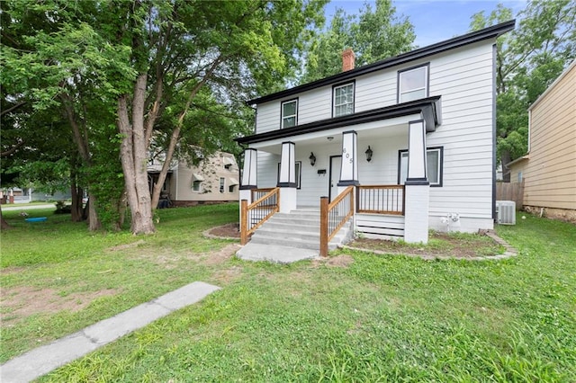 605 Oak St, Leavenworth, KS 66048 - view of front facade featuring a porch, a chimney, and a front lawn