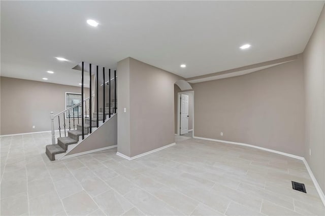 605 Oak St, Leavenworth, KS 66048 - spare room featuring arched walkways, recessed lighting, stairway, and light tile patterned floors