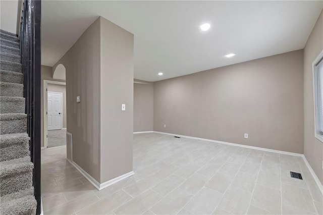 605 Oak St, Leavenworth, KS 66048 - basement featuring arched walkways, stairway, recessed lighting, and light tile patterned flooring