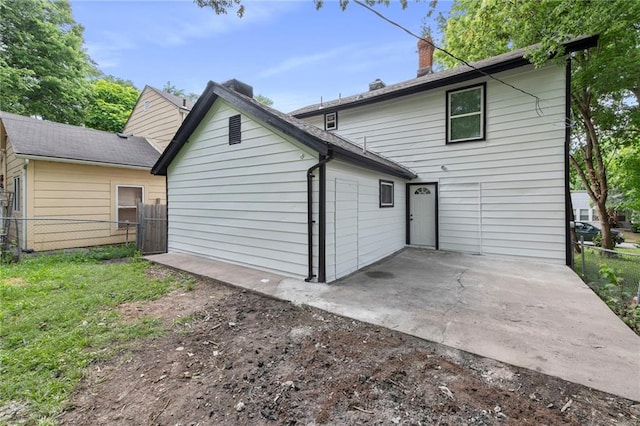 605 Oak St, Leavenworth, KS 66048 - rear view of house with a patio area and a chimney