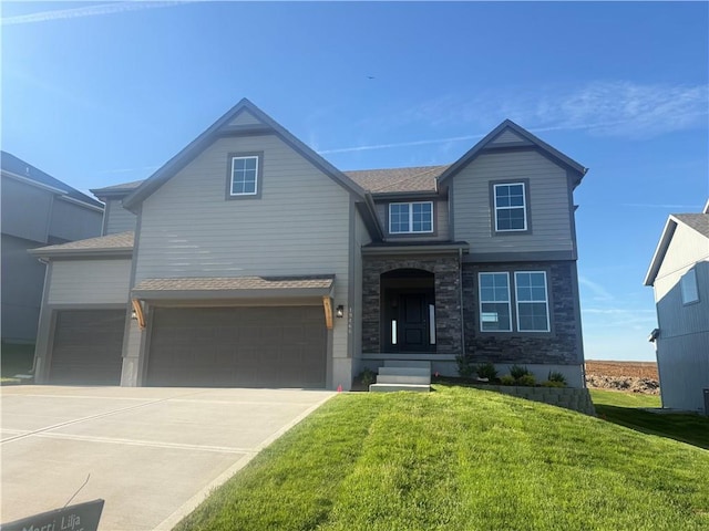 19466 W 114th Ter, Olathe, KS 66061 - view of front of property featuring a front yard, an attached garage, driveway, and stone siding