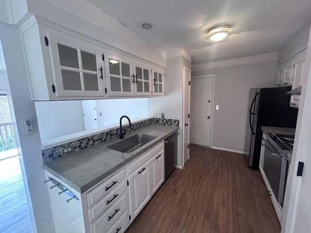 419 W 104th St Unit D, Kansas City, MO 64114 - kitchen with dishwashing machine, glass insert cabinets, gas stove, dark wood-style flooring, and white cabinets