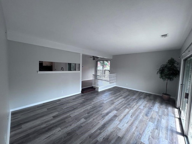 419 W 104th St Unit D, Kansas City, MO 64114 - unfurnished living room featuring dark wood finished floors and ceiling fan