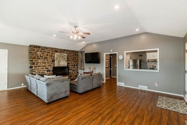 419 W 104th St Unit D, Kansas City, MO 64114 - living room with vaulted ceiling, a ceiling fan, wood finished floors, and a fireplace