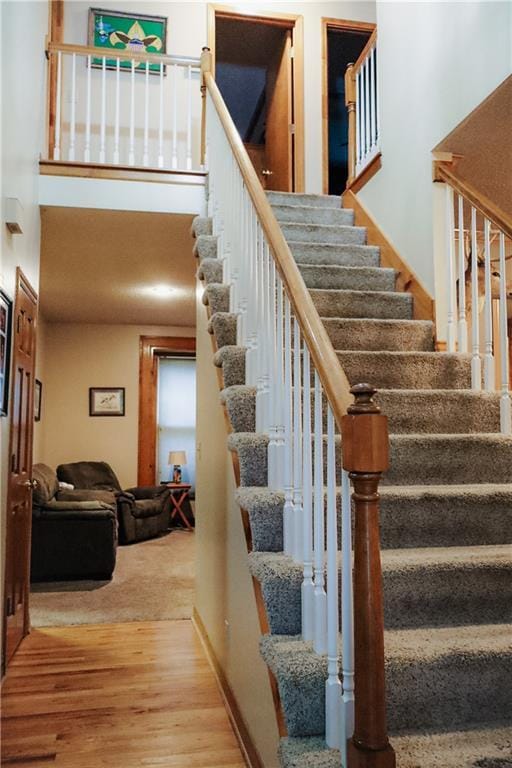 11669 S Parkwood Dr, Olathe, KS 66061 - stairs with wood finished floors and a towering ceiling