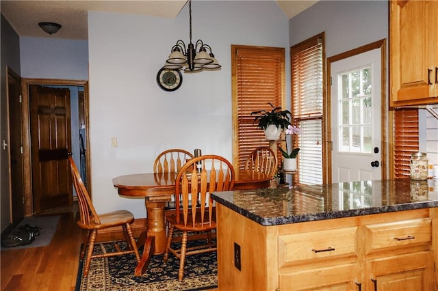 11669 S Parkwood Dr, Olathe, KS 66061 - kitchen featuring wood finished floors, a chandelier, and dark stone countertops