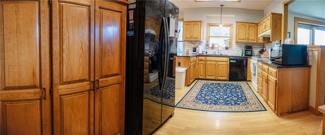 11669 S Parkwood Dr, Olathe, KS 66061 - kitchen featuring black appliances, healthy amount of natural light, backsplash, and under cabinet range hood