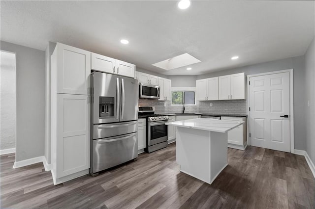 2101 Spruce St, Leavenworth, KS 66048 - kitchen with appliances with stainless steel finishes, tasteful backsplash, dark wood-style floors, and recessed lighting
