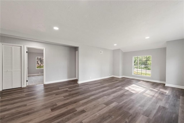 2101 Spruce St, Leavenworth, KS 66048 - unfurnished living room featuring dark wood-style floors, recessed lighting, and a textured ceiling