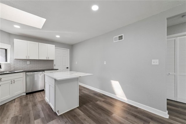 2101 Spruce St, Leavenworth, KS 66048 - kitchen with dishwasher, decorative backsplash, a skylight, dark wood finished floors, and a center island
